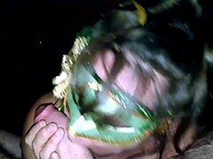 A mature woman in a green mask gives a blowjob and fucks a big cock
