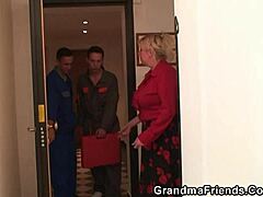 Two repairmen pleasure a busty mature woman from both ends