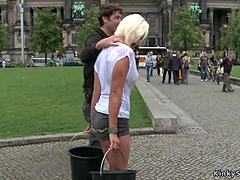 Busty blonde in public exhibitionism with humiliation and bondage